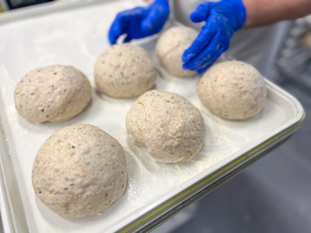 Loaves of bread being prepped for baking